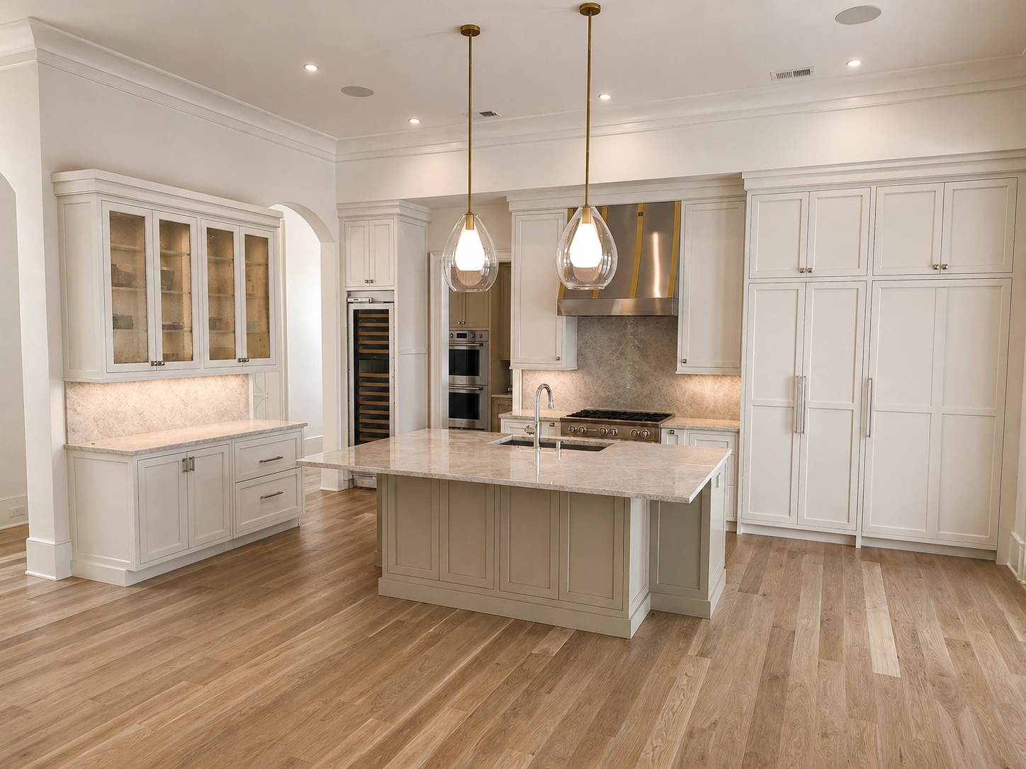 Custom build white cabinets with stainless steel range hood and sandstone counter