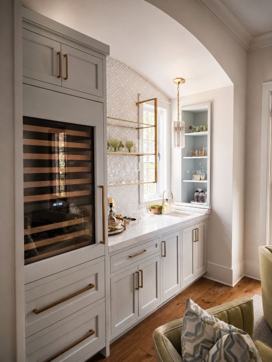 custom white cabinets with built in wine refrigerator