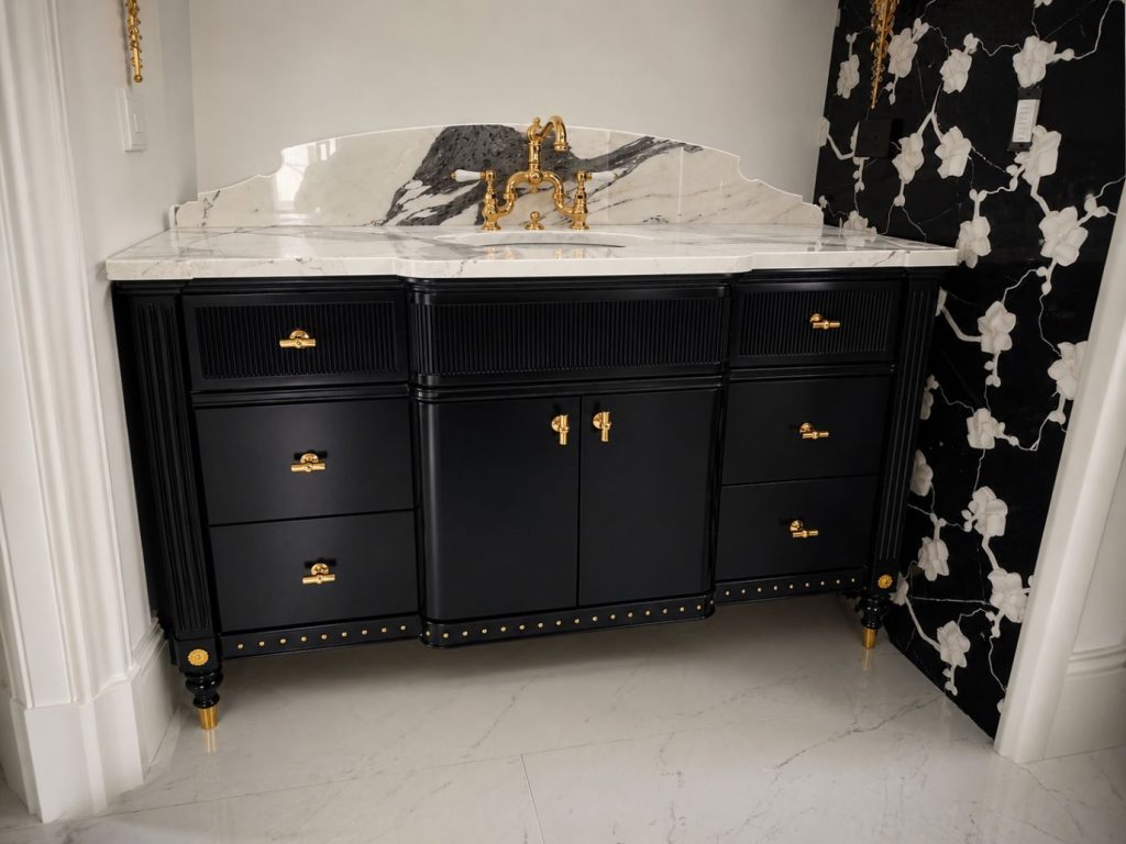 black custom bathroom vanity with arched marble backsplash and gold hardware