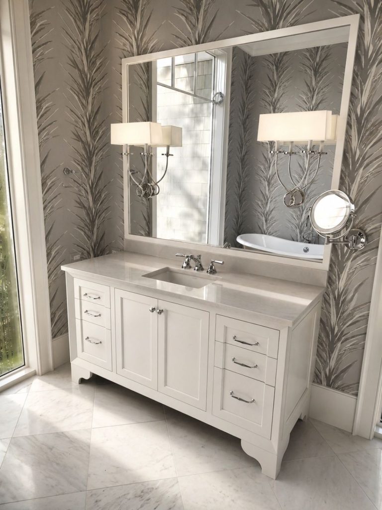 custom white bathroom vanity with limestone counter top under large custom case with mirrors