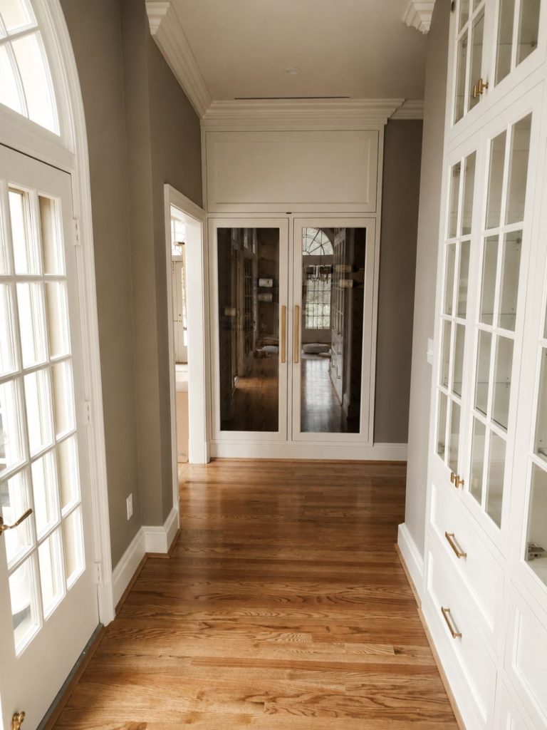 white custom built in cabinets and drawers with glass.