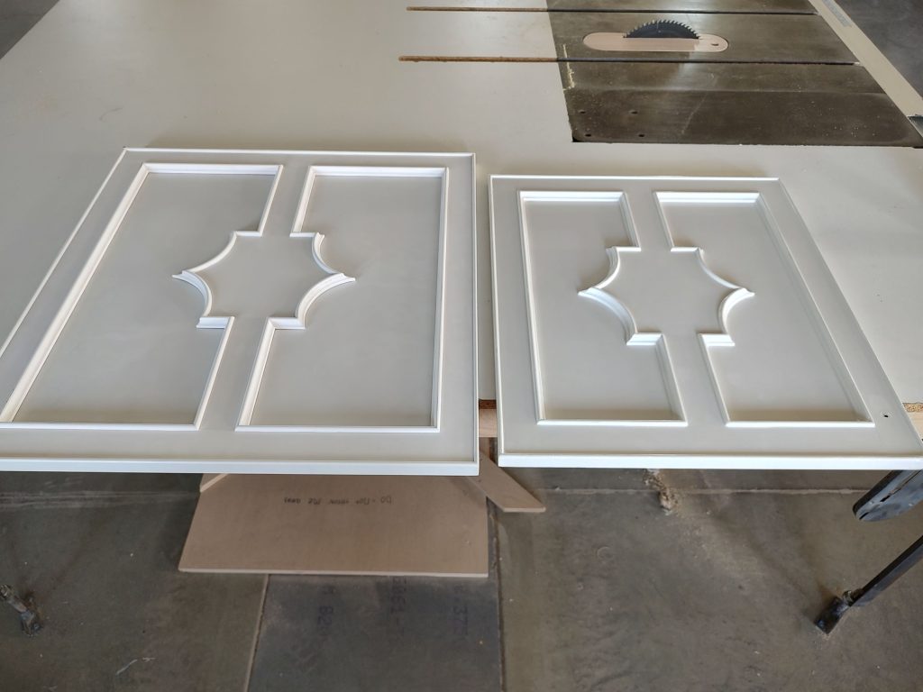 white decorative cut designed cabinets